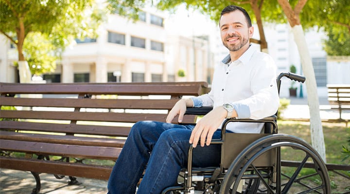 Man-outside-in-wheelchair-smiling
